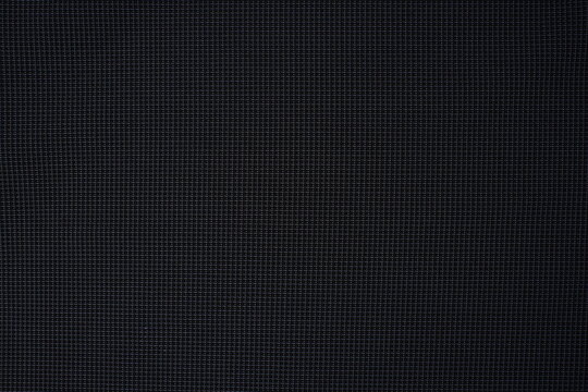 Dark black fabric texture with a fine mesh grid pattern. Close-up textile background for fashion, industrial, or technical design concepts.