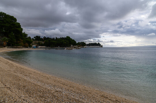 Pebble shoreline and calm sea at Ka&scaron;telet Beach, Split, Croatia
