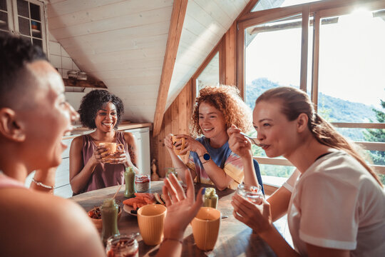 Friends enjoying breakfast in a mountain cabin kitchen