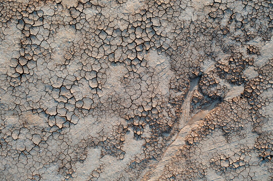 Aerial view of the cracked dry earth and salt crust patterns of Syvash lagoon in Novotroits'kyi district, Kherson Oblast, Ukraine.