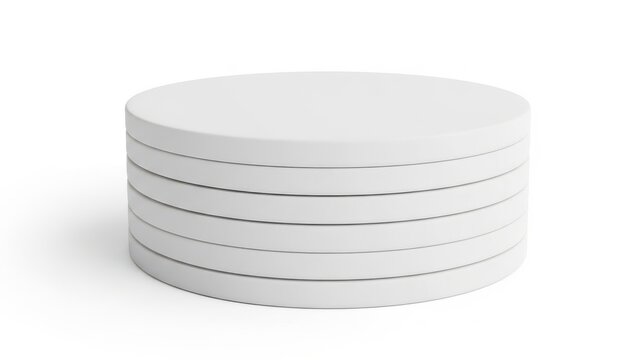 A stack of white circular cardboard pieces with a hole in the center.