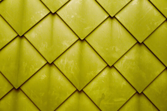 Diamond shaped fish scale tiled wall texture background