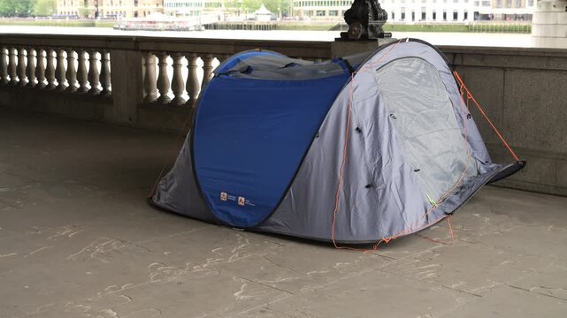 Homeless tent pitched on london south bank by River Thames