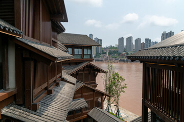 Fototapeta premium Traditional riverside architecture overlooking muddy urban river