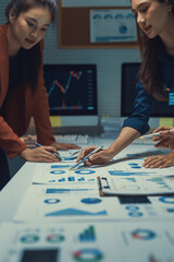 Fototapeta premium Business team collaborating on data analysis, reviewing financial reports and marketing statistics in a modern office meeting
