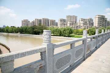 Riverside Promenade with Stone Railing and City Skyline, Jiangsu Province © NgoVan