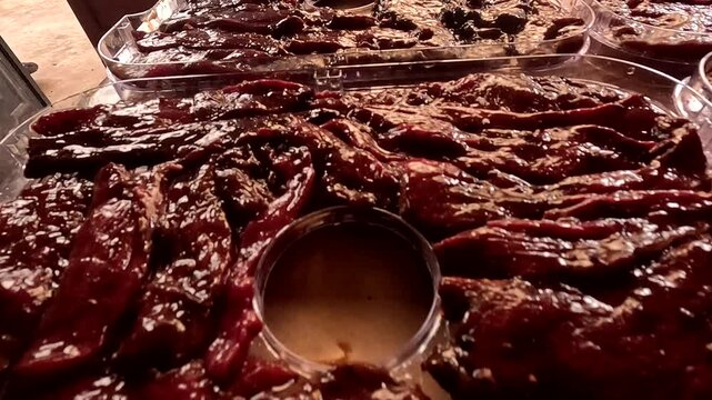 Artisanal cacao or chocolate preparation inside molded tray, showing rich red-brown texture, food production and closeup detail, suitable for stock footage about travel, nature, lifestyle