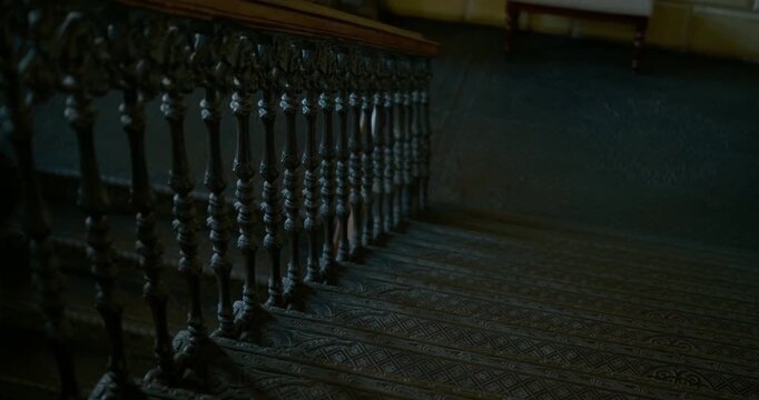 Cinematic historic mansion interior. Grey cast iron staircase with decorative patterns wooden handrails, architectural documentaries, heritage projects, travel films, luxury branding, interior design 