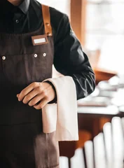 Fotobehang Horeca Professional waiter holding service towel in elegant restaurant interior  © Надія Коваль