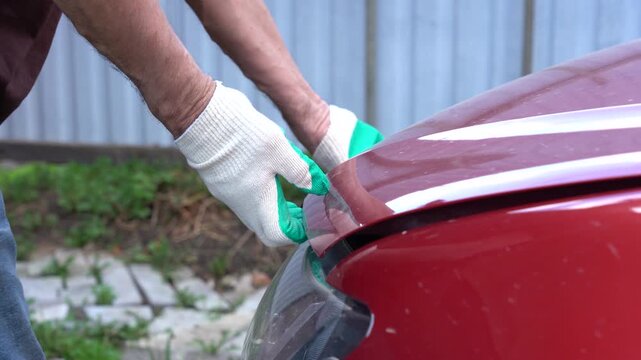 This image series captures a close-up view of a red car's hood, highlighting its shiny curves and detailing, with a person standing nearby in the final frame.