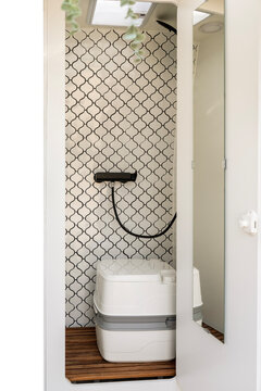 Portable toilet inside a shower installed in a camper van.
Vehicle interior, transport, travel, road trip, vacation, lifestyle