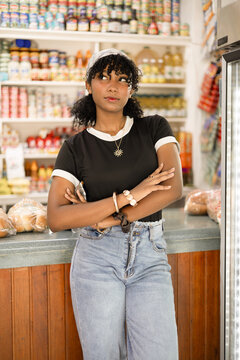 Young woman thinking contemplating in neighborhood grocery store