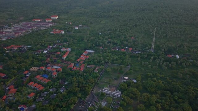 Aerial drone shot tilting down from Mount Agung volcano to Tulamben resort in Bali