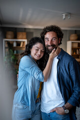Fototapeta premium Affectionate couple embracing, smiling, and connecting at home