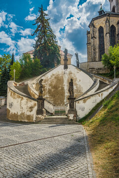 View of the statue-lined staircase leading to St. Nicholas Church in Cheb