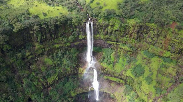 Drone shot of Vajrai Waterfall surrounded by lush green forest