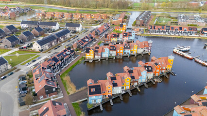 Fototapeta premium Drone aerial view of reitdiephaven groningen colorfull houses at the water
