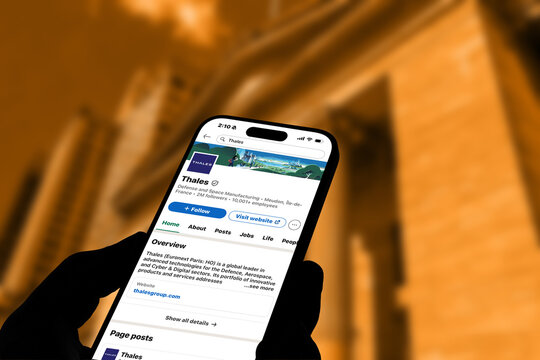 Kiel, Germany - 06-02-2026: LinkedIn profile of Thales French aerospace, defense, transportation, and security technology company displayed on smartphone in office environment