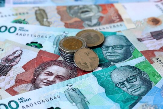 Colombian peso money banknotes and coins on table. Colombia cash bills of COP currency