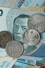 Indonesian rupiah money bills and coins on table. Indonesia cash of IDR currency © Larysa
