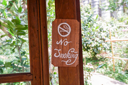 No smoking sign in outdoor place,wooden No smoking sign in cafe or restaurant, plate indicating that this is a non smoking seat,stop illness unhealthy danger sign concept.