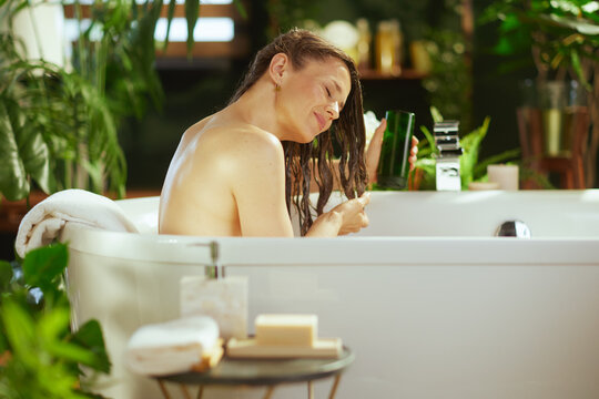 Woman Applying Hair Treatment with Eyes Closed