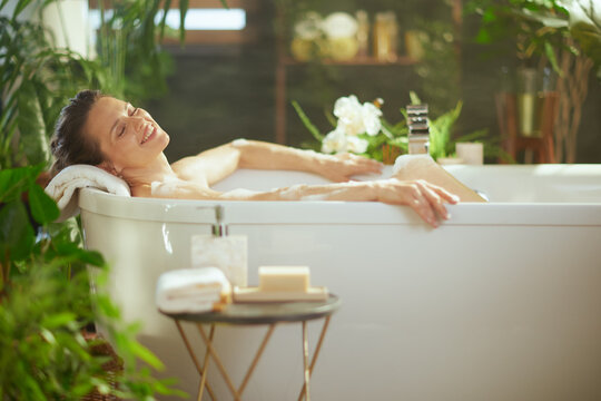 Blissful Bath: Woman in Greenery-Filled Retreat