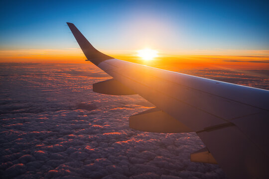 Aerial view from the plane over fluffy clouds