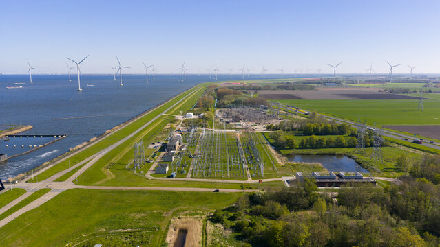 Aerial view of the Maxima plant electrical substation and ENGIE facility with offshore wind turbines in the IJsselmeer at Lelystad, Flevoland, Netherlands.