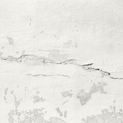 Fototapeta premium Cracked plaster wall with peeling paint and weathered texture on old exterior surface