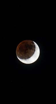 Partial Lunar Eclipse in Dark Night Sky.