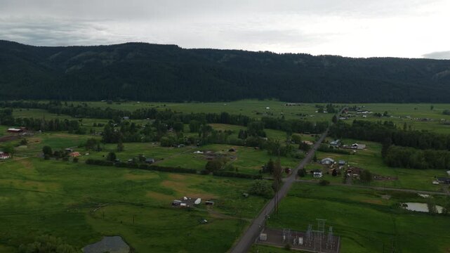 Aerial rural properties in Wallowa Oregon in spring time with cloudy sky