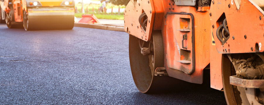 Paving Asphalt Concrete on an Urban Street During a Busy Construction Project