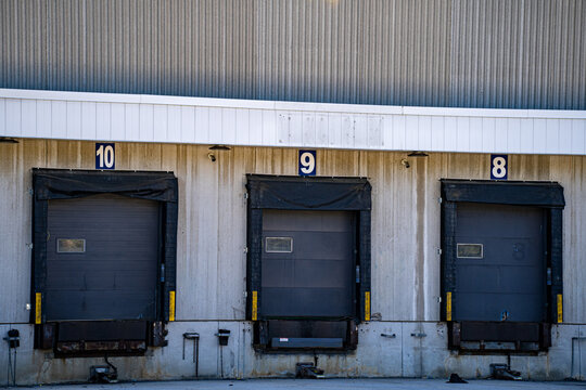 View of warehouse loading dock doors at distribution center.