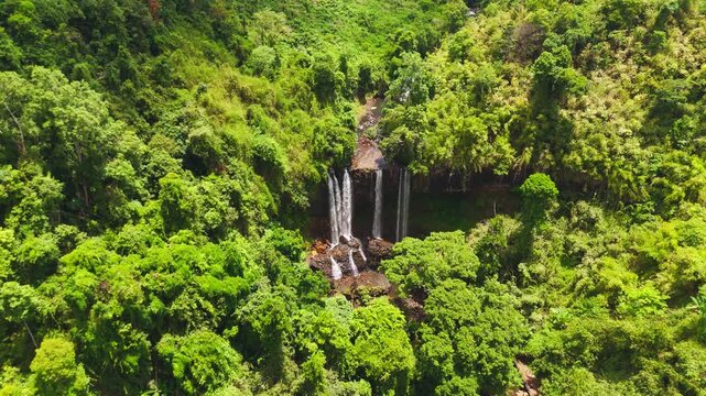 Vertical aerial drone footage of the cascading water at Tad Tayicseua Waterfall, Attapeu, Laos. Shot in portrait orientation for mobile and vertical video platforms, this cinematic clip captures the p
