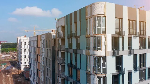 Urban construction site showcases residential development with cranes and machinery in action