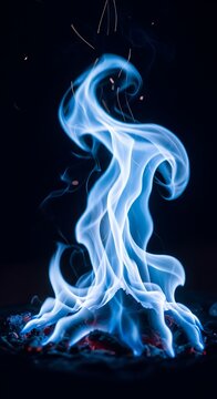 Vibrant blue flames dance ethereally against a dark background, casting a warm glow
