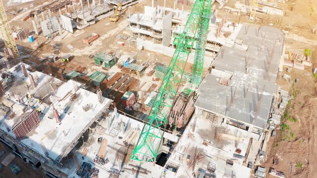 Construction progress at residential development site featuring tower cranes and active machinery for urban expansion