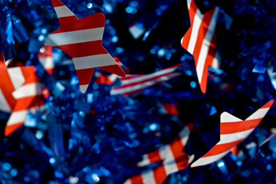 Festive patriotic American flag garland decoration with red, white & blue stars and stripes: background & symbol of democracy, freedom, government, veterans & United States federal holidays.