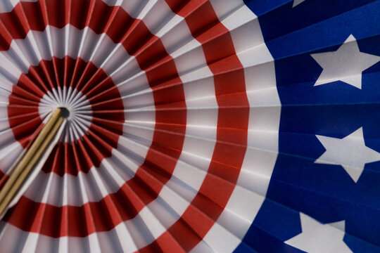 Festive patriotic American flag fan decoration with red, white & blue stars and stripes: graphic americana symbol of democracy, freedom, government, veterans & United States federal holidays.