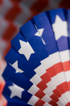 Patriotic American flag fan decoration with red, white & blue stars and stripes: background and graphic symbol of democracy, freedom, government, veterans & United States federal holidays.