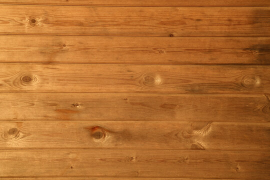 Texture of the wall made of orange varnished wooden boards panels with multiple knots wood pattern texture kitchen background Table top surface empty blank mockup Tabletop top front view backdrop