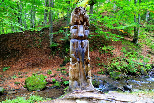 Hand-carved wooden statue of a Hutsul man in the Carpathian forest