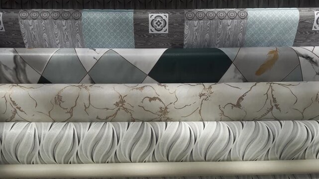 Assorted types of oilcloth and wallpaper displayed on a storefront window in a hardware store. A variety of patterns, textures, and colors are shown, highlighting home renovation and interior design m