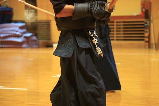 Focused martial artist grips sword with precision