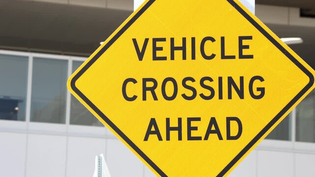 Yellow Vehicle Crossing Ahead Road Sign In Sunlight