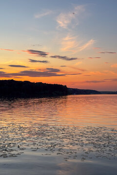 A peaceful walk on sunset unfolds along the Ternopil Pond in Ternopil, Ukraine, where calm waters and lush surroundings create a serene urban retreat.
