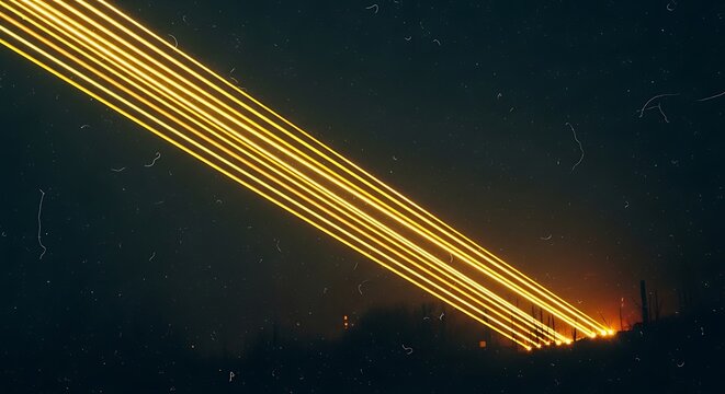 Long exposure light trails of multiple beams of light shining into the night sky from a dark landscape