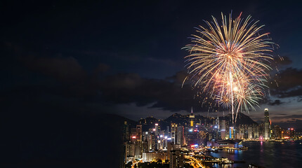 Fototapeta premium Vibrant fireworks display over a coastal metropolis at night