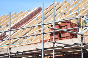 New housing building work on roof beams and brick work of property  © Ian